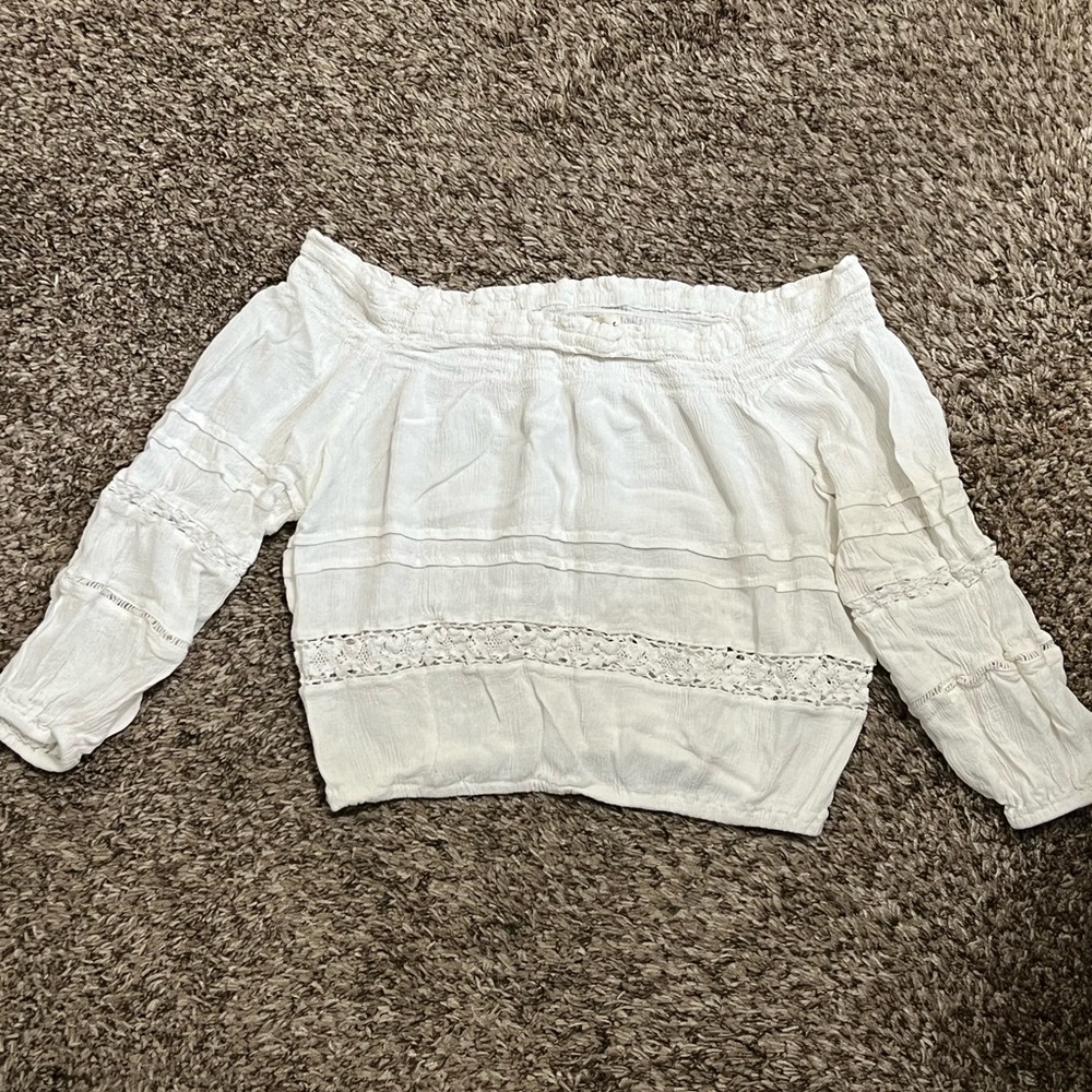 Woman’s cropped white shoulder top